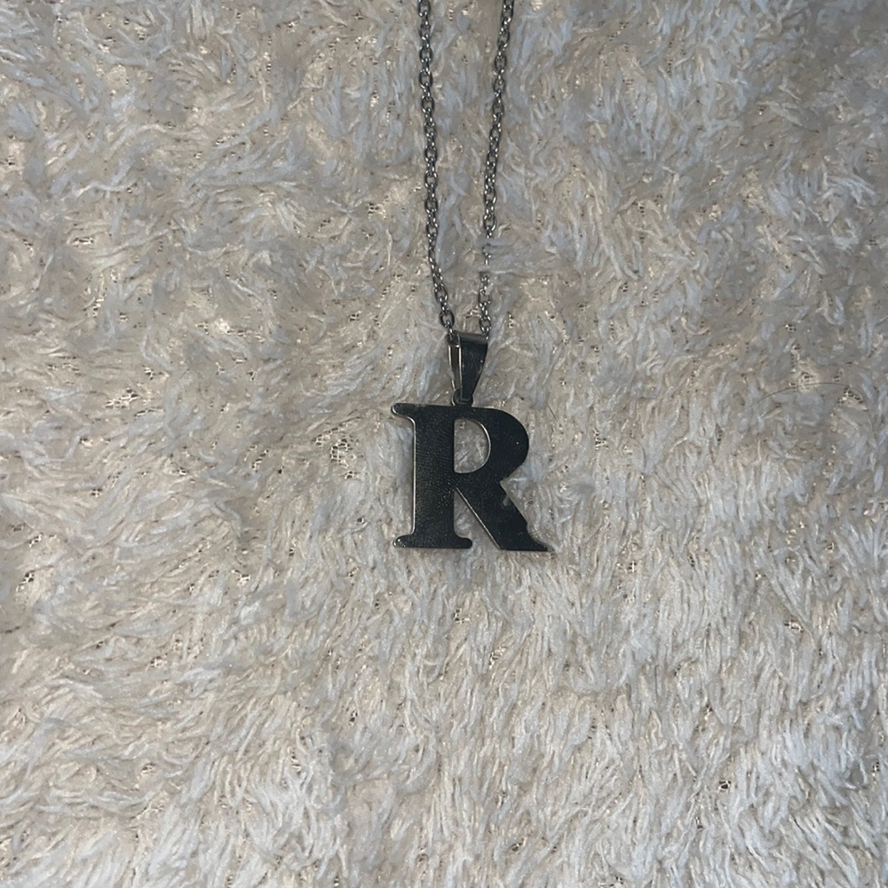 silver necklace with “R” charm